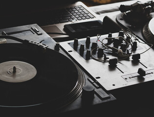 DJ playing music at a hip hop party. analog turntable, Dj uses turntable and mixer for scratching.