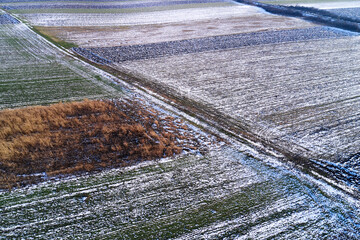 Aerial view of frozen fields in winter from drone pov