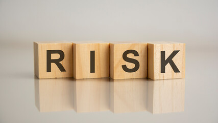 Four wooden cubes with letters risk. Business marketing concept.