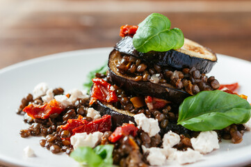 Eggplant lentil stacks with soy cheese, sun dried tomatoes and basil leaves.