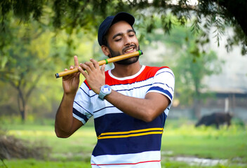 playing bansuri flute indian wind instrument