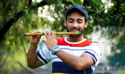 playing bansuri flute indian wind instrument