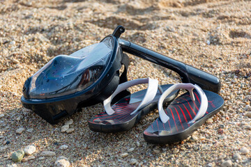 Full face snorkeling mask lying on the seashore