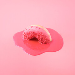 Creative food concept. Pink donut melts on a pink background.