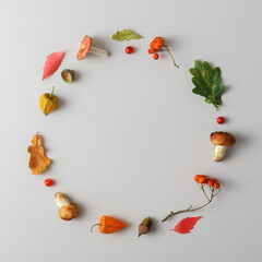 Minimalistic autumn wreath on gray background with copy space.