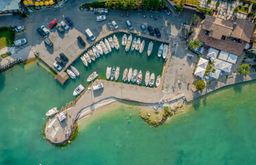 Fototapeta na wymiar Aerial view of a small port of a Sirmione town in Garda lake, Italy