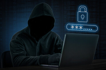 Man with black hoodie, hacker using laptop to hack password, Hacking concept. © 8 studio