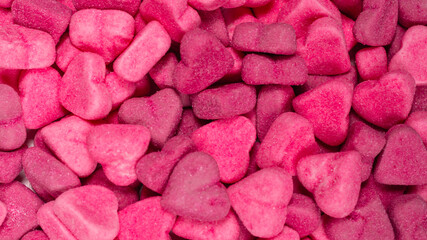 Assorted tasty gummy candies. Pink jelly sweets background.
