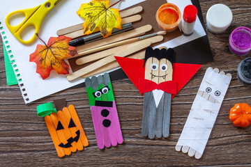Halloween ghost, pumpkin, mummy and vampire toy gift stics puppets on wooden table. Handmade....