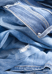 background of blue crumpled jeans. Close up 