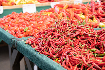 fresh organic Chili Peppers on display at a farmers market