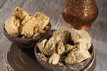 Oriental, traditional halva sweet, two types of peanut and sunflower in ceramic bowls similar to coconut. Close-up..