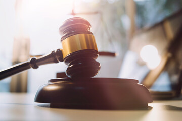 Justice and law concept.Male judge in a courtroom with the gavel, working with, computer and...