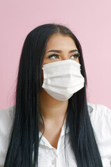 Girl with black hair and a mask on a pink background