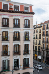 Facade of vintage building with large viewpoints to the street in the center of Madrid