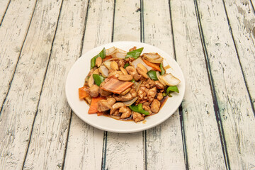 Chicken with almonds and chunks of green peppers sautéed with white onions with wok-sautéed carrots with soy sauce
