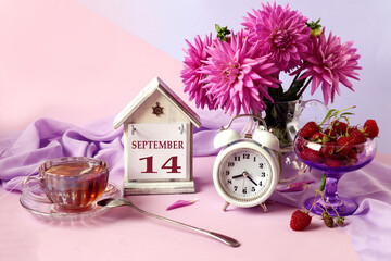Calendar for September 14 : the name of the month in English, cubes with the number 14, a bouquet...