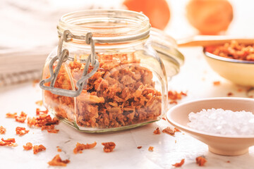 Making homemade fried onions with ingredients on white kitchen table