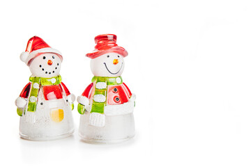 closeup of snowman and snow woman traditional Christmas decoration on a white background with copy space