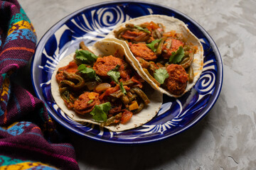 Mexican food. Chorizo and nopales tacos on grey background