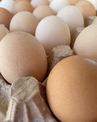 Overhead view of free-range organic chicken brown eggs in tray. Background with chicken eggs. Eggs for Easter. Background for cafes, restaurants, fast food outlet. Craft background.