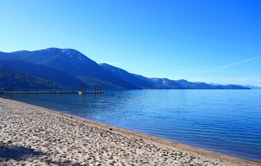 Landscape view of Lake Tahoe with snow-covered mountains and forests seen from Incline Village on...