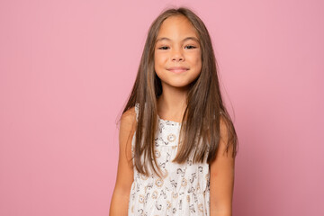 Closeup portrait beautiful smiling girl isolated over pink background.