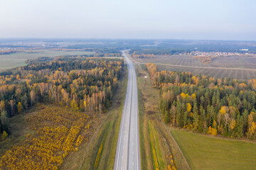 Aerial view of freeway road in autumn forest.