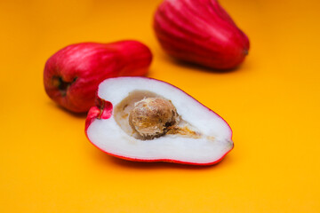 Jambu Bol or Jambu Jamaica isolated on orange background also known as Malay red rose Apple (Syzygium Malaccense).