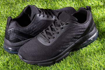 Sports shoes on synthetic grass - Text space