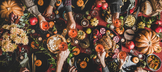 Family or friends celebrating Thanksgiving day with rose wine - obrazy, fototapety, plakaty