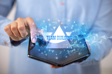 Businessman holding a foldable smartphone, business concept