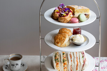 Afternoon tea with cakes, scones and sandwiches