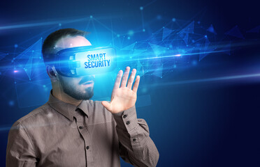 Businessman looking through Virtual Reality glasses, virtual security concept