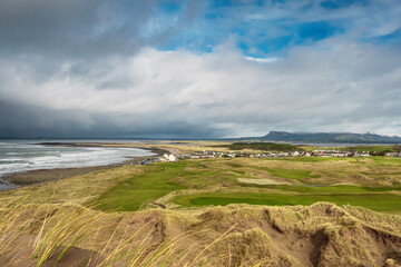 View on Strandhill beach and town in county Sligo, Ireland. Popular holiday destination for nature scenery and surfing sport. Dramatic storm clouds over the ocean