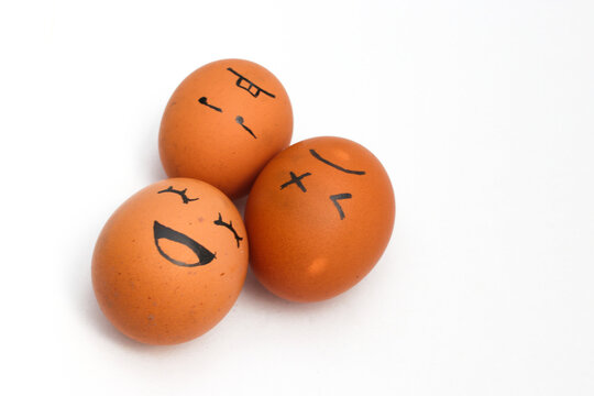 a Group of brown chicken eggs with happy, annoyed, and tired faces isolated on white background.