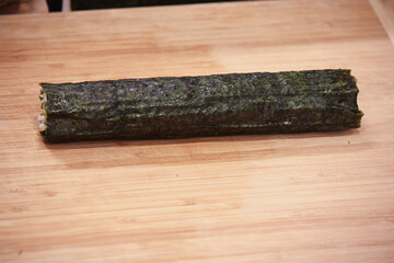 Fototapeta premium Cucumber sushi roll preparation – final unsliced 