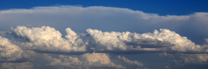 Fototapeta na wymiar Compact clouds over a dark blue sky