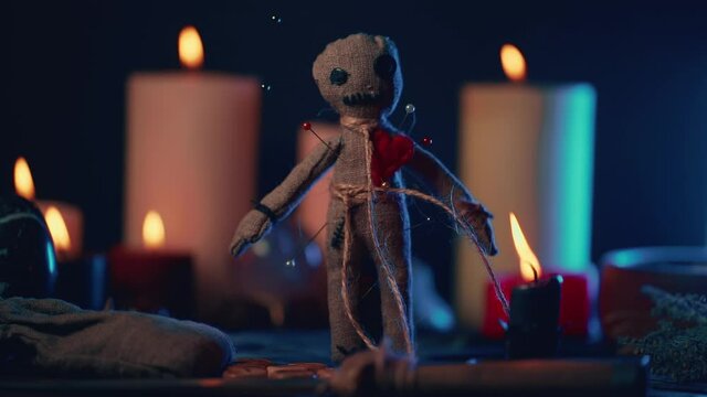 Voodoo Magic concept. Witchcraft with rag doll. Close-up of puppet nipped with needles.