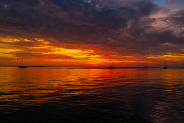 Fototapeta na wymiar Ocean sunset on sky background with colorful clouds. Calm sea with sunrise sky.