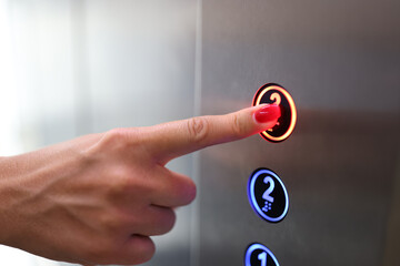 Woman finger presses a button in elevator closeup © megaflopp