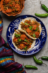Mexican food. Chorizo and nopales tacos on grey background