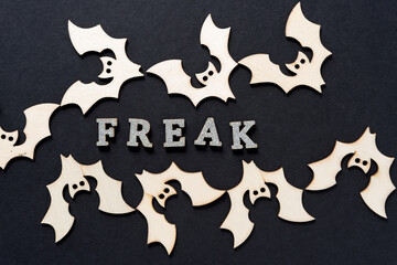 wooden bats and the message "freak" in glitter letters
