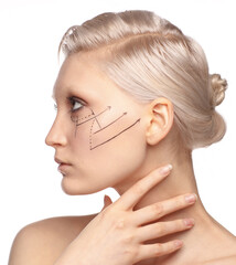 Pretty fashionable white blonde girl with perforation lines on face, plastic surgery concept, close...