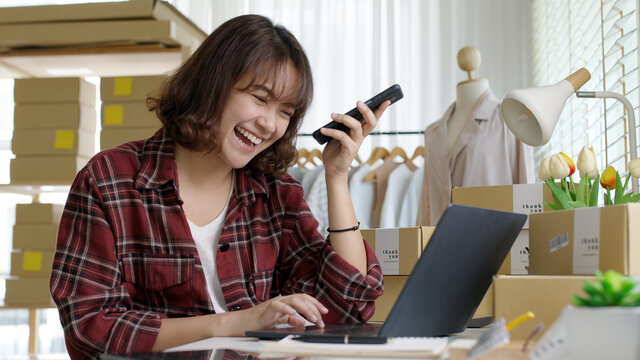 Young Asia Seller Woman Happy Work On Laptop Busy Cellphone Call Chat To Customer At Home Office Desk Use Digital Tablet Computer In SME Online Store Social E-commerce Sale Page Service Web Support.