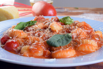 pasta in white sauce with parmesan cheese, tomato, basil, herbs, delicious food from Italian and French cuisine