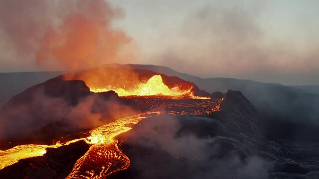 Orbit shot around boiling magma in active volcano crater at dawn. Mass of hot lava flowing down in streams. Fagradalsfjall volcano. Iceland, 2021