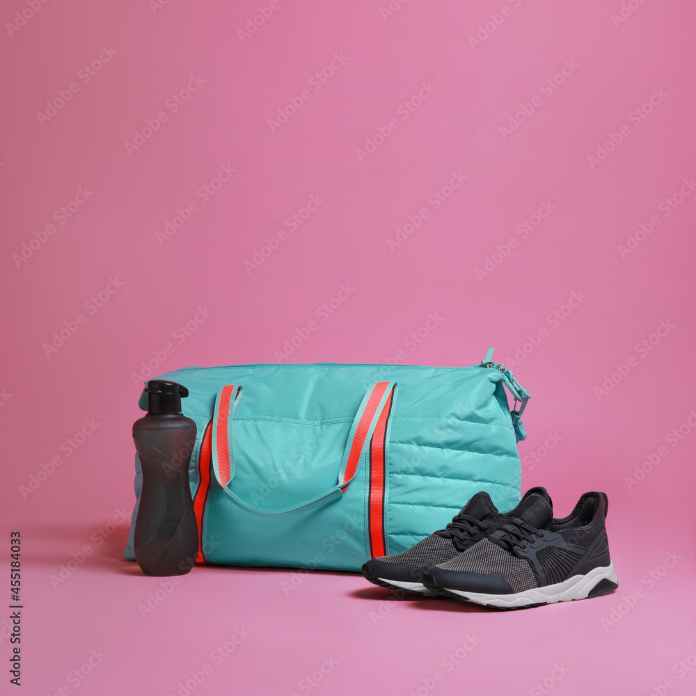 Sticker Blue gym bag and sports accessories on pink background