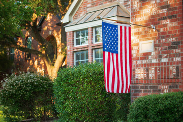American flag flying at half-staff of a residential home - 455184683