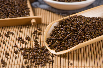 Chinese herbal medicine cassia seeds on wood background